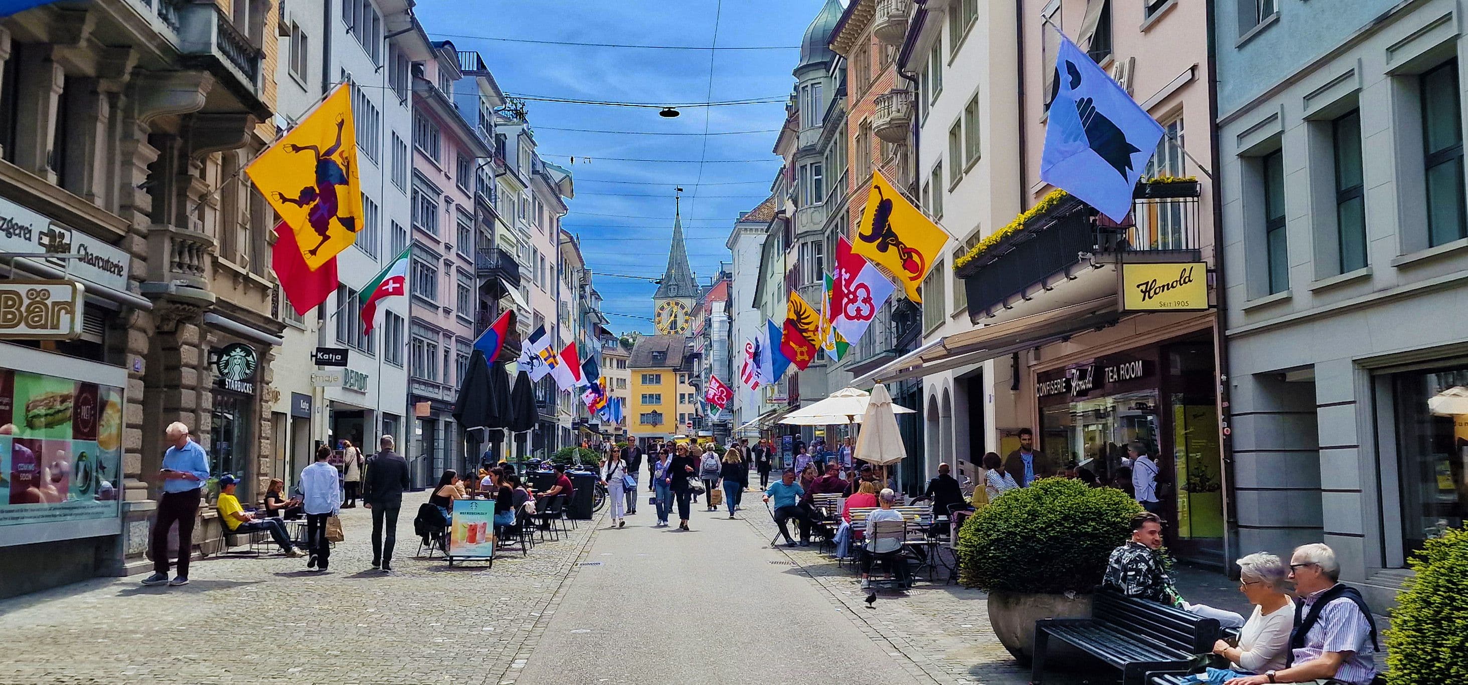 Zurich: lively city tour with people, shops, and impressive architecture.