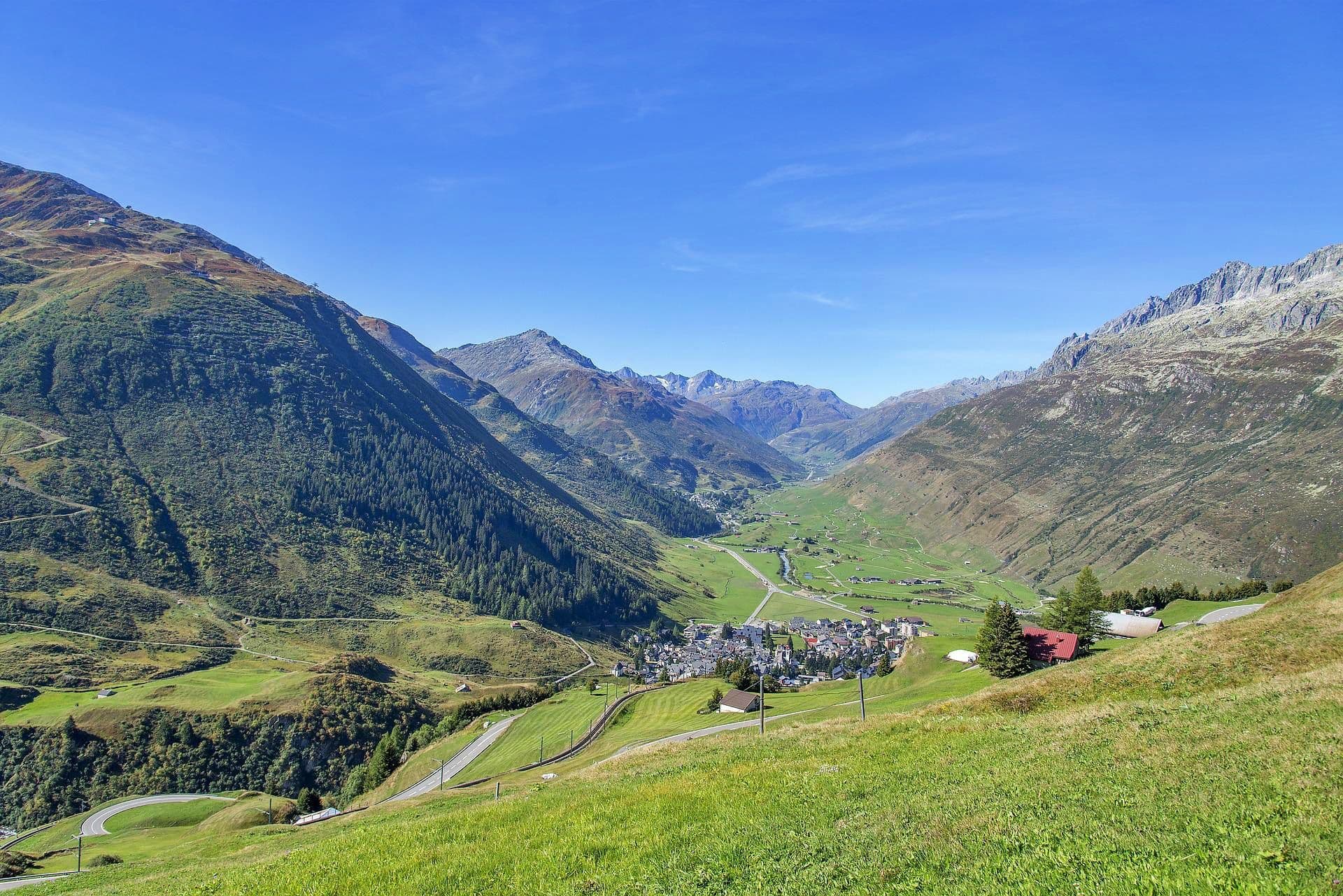 Andermatt: picturesque landscape with mountains and the charming village in summer.