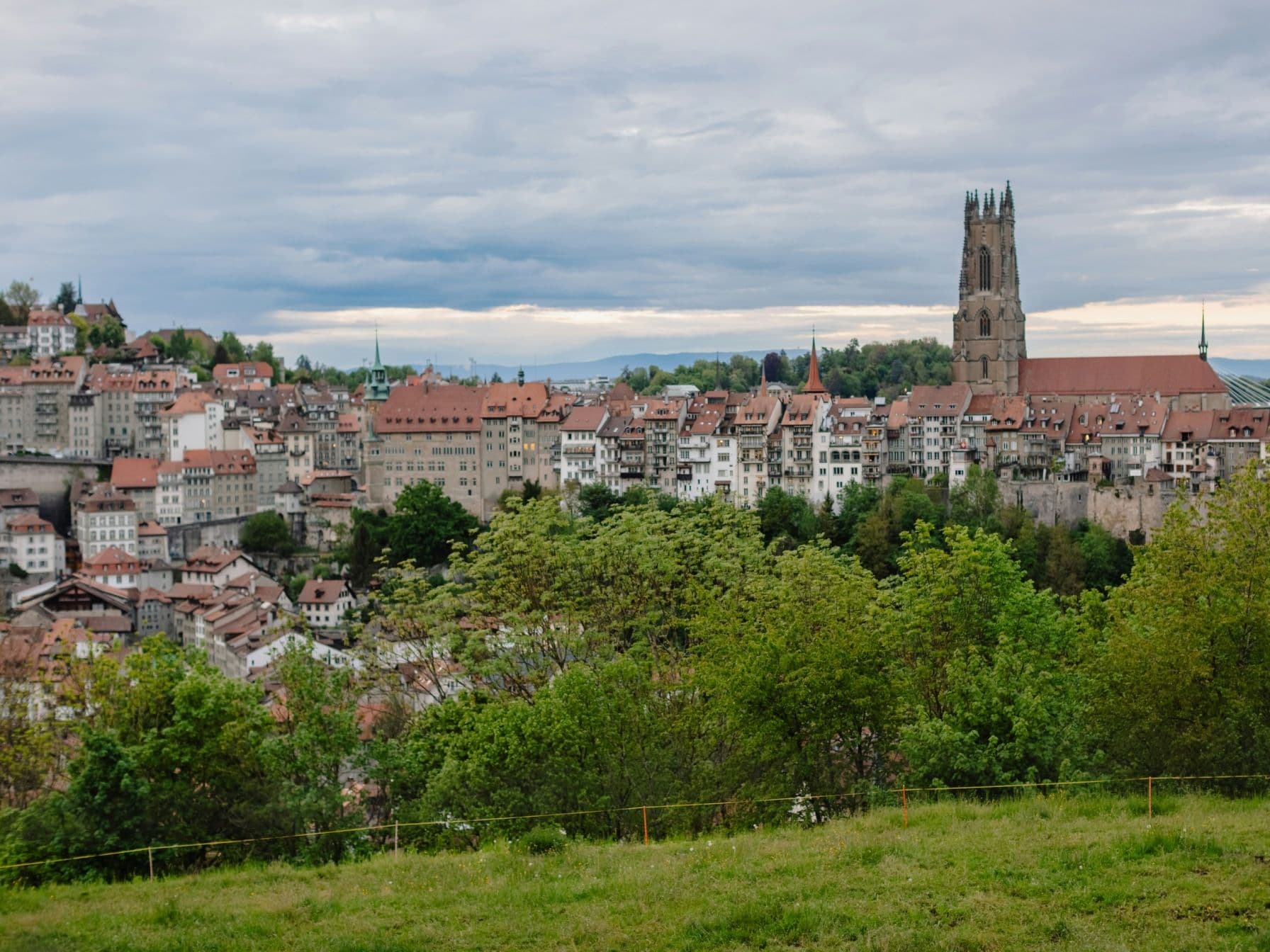 Fribourg: picturesque city view with mountains and nature in the background, ideal for exploring and photographing.