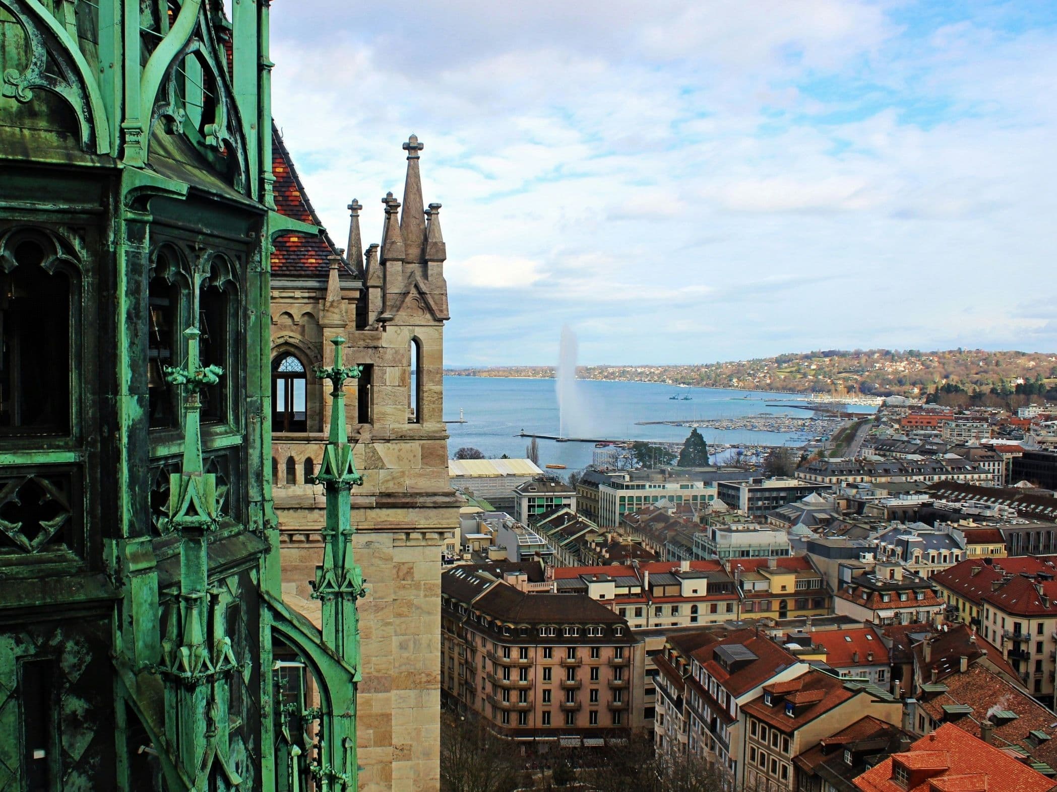 Geneva: View of Lake Geneva and the fountain with historic buildings in the background.
