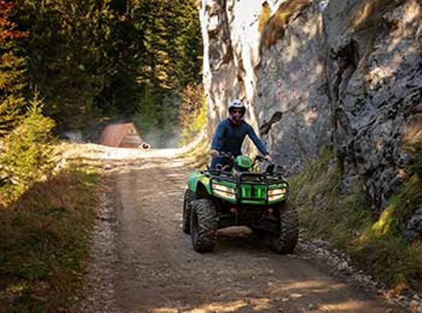 Quad tour in the Allgäu, driver on ATV, forest path