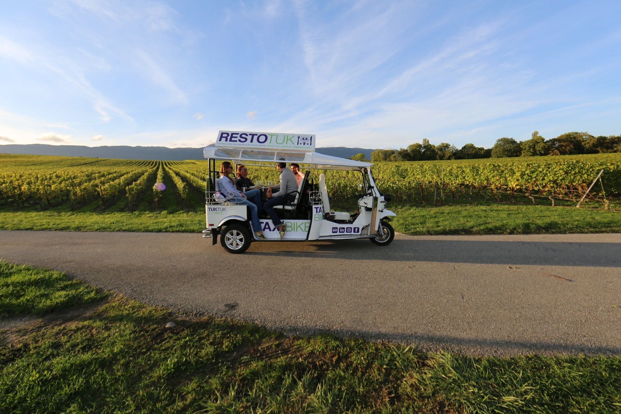 Tuktuk tour through Geneva's vineyards with views of the gentle hills and nature.