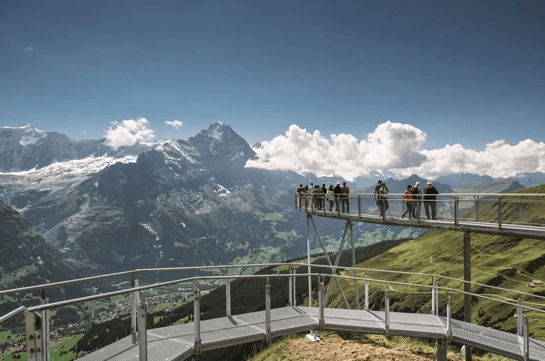 Grindelwald Mountain Cart on a viewing platform overlooking the mountains and the valley