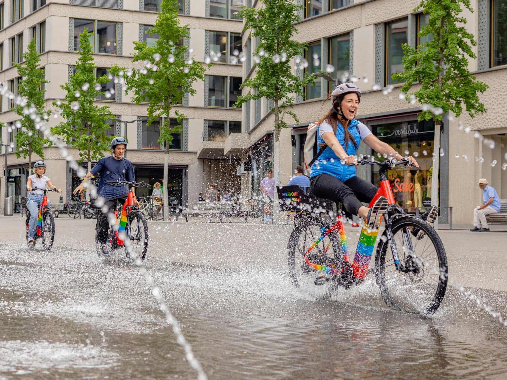 E-Bike Tour in Zurich with cheerful riders and refreshing splashes of water.
