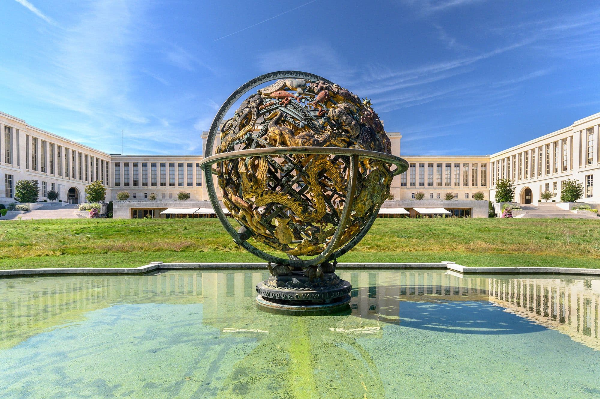 Globe at the UN building in Geneva reflects the clear sky.