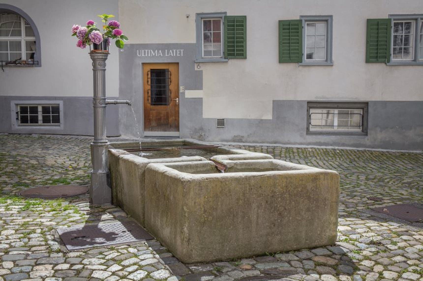 Mysterious Chur with historic fountain and flowers